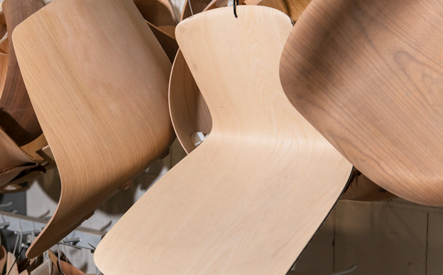 Close-up of innovative 3D-Veneer chair shells, showcasing patented wood application technology.